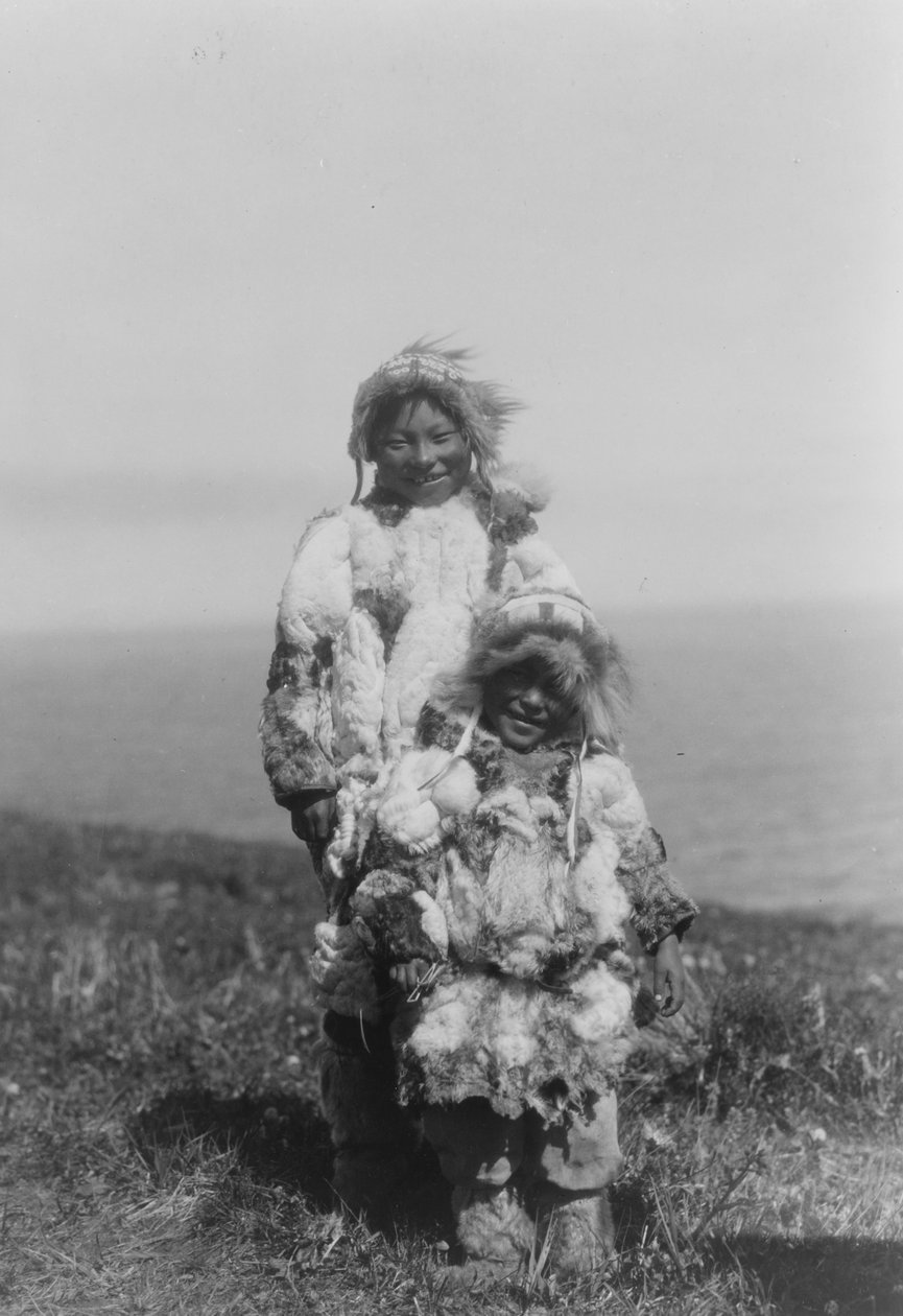 Ein kleines Kind und ein älterer Eskimo in Entenhautparkas, Insel Nunivak, Alaska, ca. 1929 (s/w Foto) von Edward Sheriff Curtis