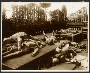 Sechs männliche Modelle als antike Krieger in Rüstung, die tot spielen von Alphonse Maria Mucha
