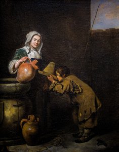 Junger Schornsteinfeger trinkt in der Nähe eines Brunnens
