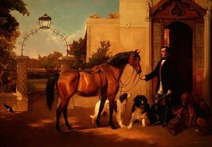 Ein Gentleman mit seinem Jagdhund und Hunden vor seinem Haus