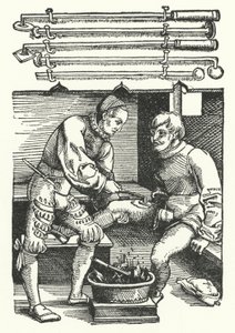 Ein Chirurg kauterisiert die Beinwunde eines Soldaten von German School