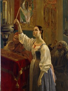 Mädchen stellt eine Kerze vor eine Ikone. In einer orthodoxen Kirche am Gründonnerstag der Osterwoche.