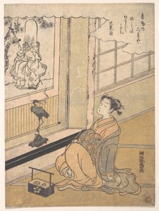 Junge Frau in einem Raum sitzend und ein Kakemono von Fukurokujin betrachtend von Isoda Koryusai