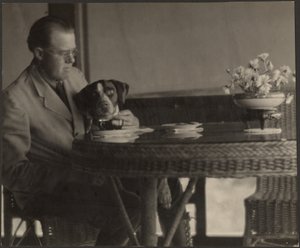 Mann und Hund am Tisch sitzend von Louis Fleckenstein