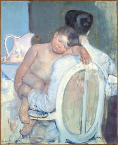 Frau sitzt mit einem Kind auf dem Arm, ca. 1890