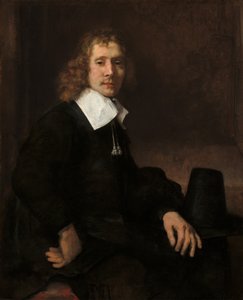 Ein junger Mann sitzt an einem Tisch, möglicherweise Govaert Flinck von Rembrandt van Rijn