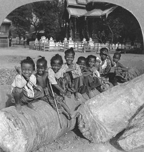 Burmesische Kinder sitzen auf einem Palmenstamm, Burma, 1908 von Stereo Travel Co