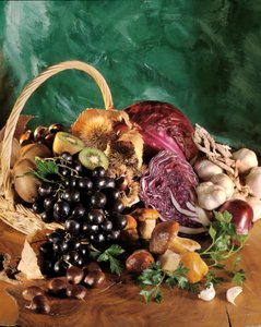 Diät: Stillleben mit schwarzen Trauben, Knoblauch, Zwiebel, Knoblauchzehe, Petersilie, Pilz, Kastanie, Kiwi und Rotkohl.