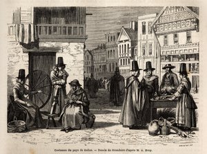 Eine Straße in Wales, mit Einheimischen in traditionellen Kostümen und alltäglichen Aktivitäten: eine Familie und Frauen, die Wolle mit Rädern spinnen. Gravur zur Illustration einer Reise in das Land Wales, 1862, von Alfred Erny, in „Le tour du monde, nouv von Unknown artist