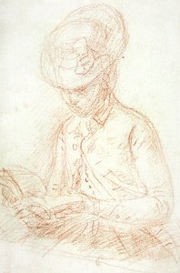 Frau in Reitkleidung beim Lesen
