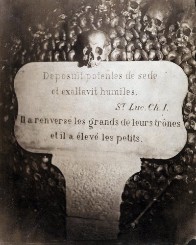 Die Beinhäuser der Katakomben von Paris. Peter trägt ein Zitat aus Kapitel 1 des Evangeliums von Lukas (Deposuit potentes de sede et exaltavit humiles. Auf Französisch: Er stürzte die Großen und erhob die Kleinen) von Nadar