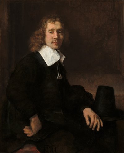 Ein junger Mann sitzt an einem Tisch, möglicherweise Govaert Flinck von Rembrandt van Rijn
