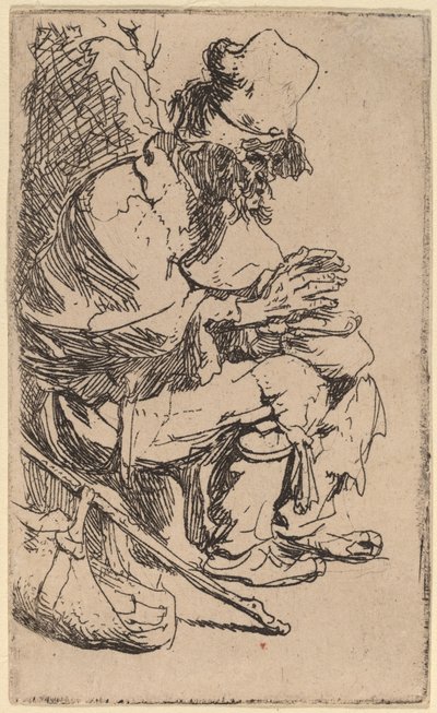 Bettler sitzt und wärmt seine Hände an einer Kohlenpfanne von Rembrandt van Rijn