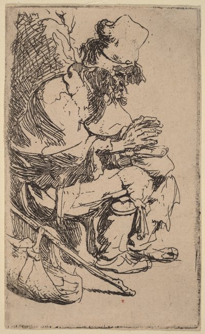 Bettler sitzt und wärmt seine Hände an einer Feuerpfanne von Rembrandt van Rijn