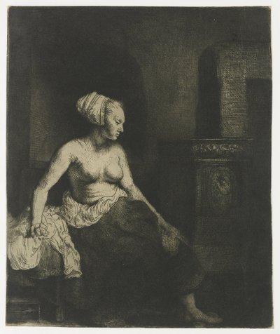 Frau sitzt halb angezogen neben einem Ofen von Rembrandt van Rijn