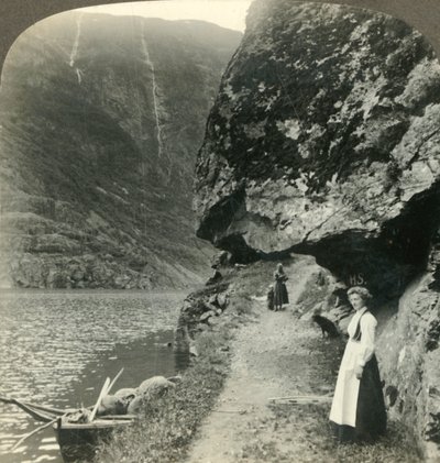 Wo die Straße unter den vorspringenden Klippen am Wasser des Nerofjords, Norwegen, ca. 1905, entlangkriecht von Unbekannt