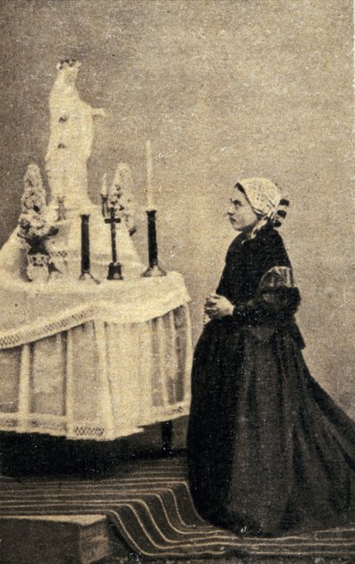 Bernadette Soubirous kniend vor einem Altar mit der Jungfrau Maria von Unknown photographer