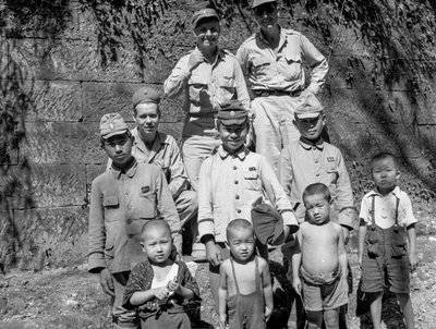Amerikanische Soldaten posieren mit japanischer Familie nach der Kapitulation Japans von Volkmar Wentzel