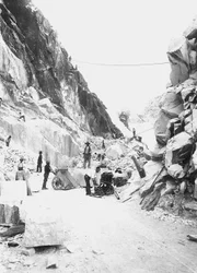 Bagger bei der Arbeit in einem Marmorsteinbruch in den Apuanischen Alpen, Toskana