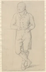 Porträt eines stehenden Mannes, mit gekreuzten Beinen, an ein Sofa gelehnt