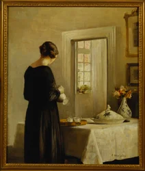 Ein Interieur mit einer Frau an einem Tisch