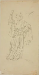 Bewaffneter Araber, der sich an eine Wand lehnt