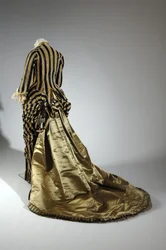 Abendkleid, ca. 1884 (Rückansicht). Seidensatin und geschnittenes Samt, Spitze, Seidenfadenquasten und Fransen. Charles Frederick Worth, Frankreich.