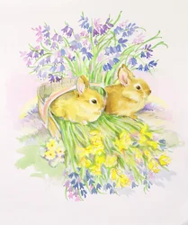 Kaninchen in einem Korb mit Narzissen und Glockenblumen