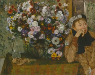 Eine Frau sitzt neben einer Vase mit Blumen