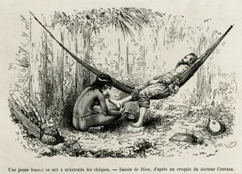Eine junge Roucouyan-Frau entfernt die Dornen, die sich während der Nacht in die Füße des Entdeckers gebohrt haben. Gravur von Riou, zur Illustration der Geschichte De Cayenne aux Andes, von Jules Crevaux, Arzt der französischen Marine, in den Jahren 1878-
