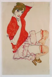 Wally in roter Bluse mit erhobenen Knien