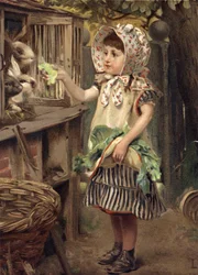 Kleines Mädchen füttert Kaninchen
