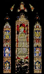 Das Ostfenster (Ew) mit musizierenden Engeln, die eine heilige Bischofsfigur umgeben