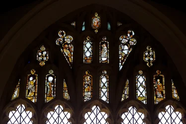 Fenster Ew, die Maßwerklichter mit Gott, der Dreifaltigkeit, St. Peter, St. Paul, St. Katharina und Gabriel: und ein Vogel