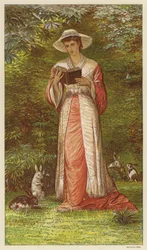 Frau liest ein Buch in einem Garten mit Kaninchen