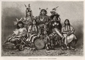 Indische Krieger und ihre Frauen (Texas). Gravur nach der Zeichnung von E. Ronjat, zur Illustration der Geschichte „La conquete blanche“, von William Hepworth Dixon, 1875, veröffentlicht in „Le tour du monde“ 1876, herausgegeben von Edouard Charton, Hachet