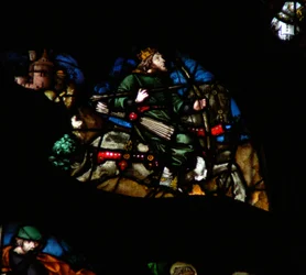 Das westliche Rosenfenster zeigt eine Szene aus dem Buch der Offenbarung: Ein Mann auf einem weißen Pferd mit Bogen, Pfeilen und Krone (6:2).