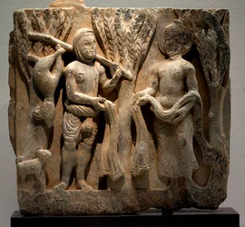 Kleidertausch mit einem Jäger. Skulptiertes Flachrelief, Gandhara-Kunst (Pakistan), 2.-3. Jahrhundert. Nationalmuseum von Korea, Seoul (Südkorea).