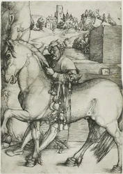 Ein Stallknecht zäumt ein Pferd