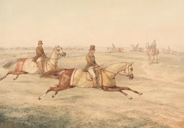 Zwei Reiter trainieren Pferde im Galopp