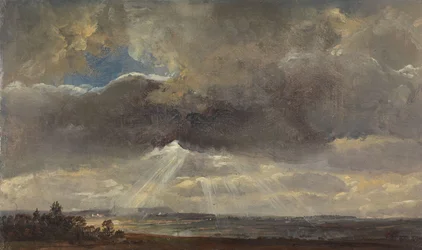 Wolken und Sonnenstrahlen über dem Windberg bei Dresden