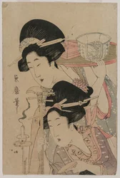 Zwei Geishas neben einer Kerze
