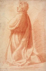 Junger Mann, der im Profil nach links kniet