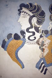 Minoische Kunst. Details des Freskos „Damen in Blau“. Komposition einer reich gekleideten und üppig mit Schmuck behängten weiblichen Figur vor blauem Grund. Trotz seines fragmentarischen Zustands vermittelt dieses Wandgemälde den Eindruck von Opulenz und