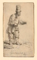 Ein Bauer mit hoher Mütze, stehend und auf einen Stock gelehnt