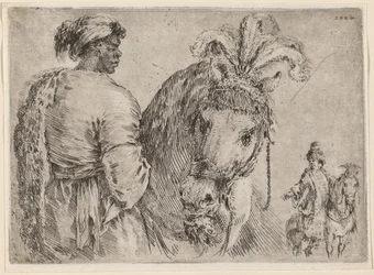 Ein Schwarzer Mann füttert ein Pferd