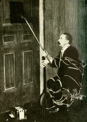John Nevil Maskelyne führt eine Geisterkabinett-Illusion vor, ca. 1910