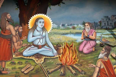 Gemälde eines heiligen Mannes (sitzt auf einer Tigerhaut wie Shiva) umgeben von Anhängern, Haridwar, Indien