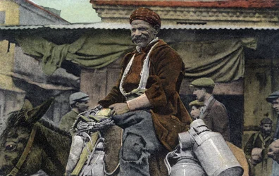 Griechenland, Saloniki: lächelnder Mann reitet auf einem Esel mit Dosen auf dem Marktplatz - Postkarte 1914-1918