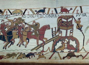 Die Armeen von Wilhelm dem Eroberer zogen aus, um gegen den Herzog der Bretagne zu kämpfen. Harold wurde gerade von Wilhelm zum Ritter geschlagen (Detail des Teppichs von Bayeux)